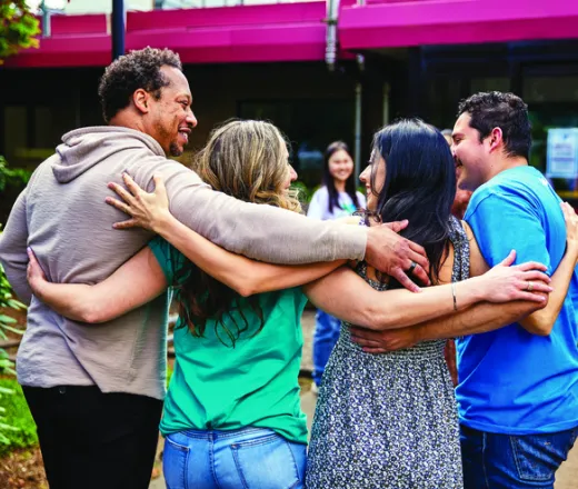 Group Photo of 4 Adults at Welcoming Week