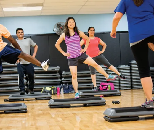 Group of diverse people exercises together